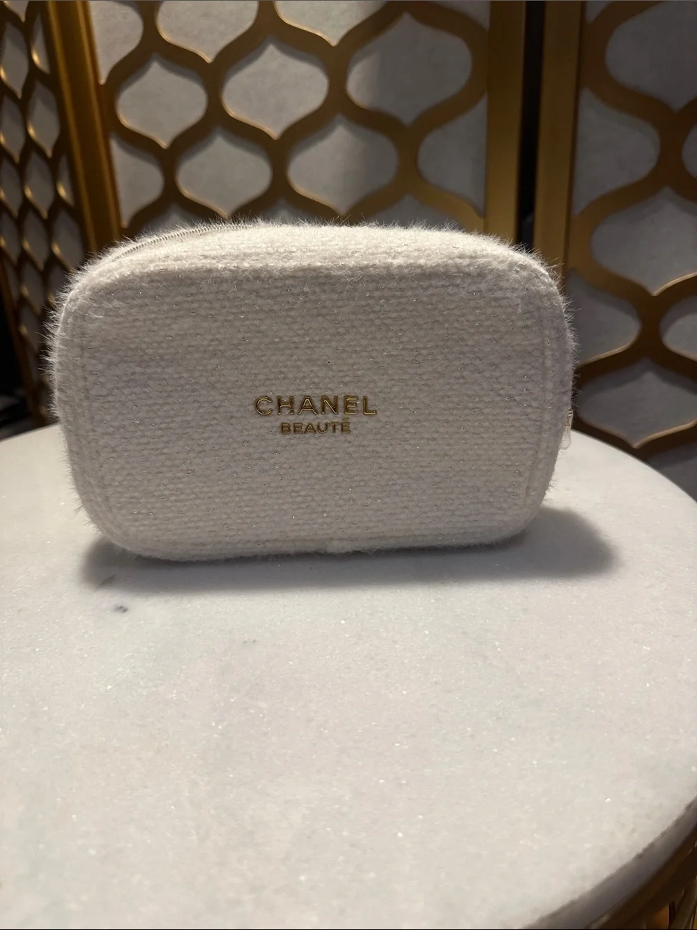 CHANEL cream boucle cosmetic pouch with gold logo